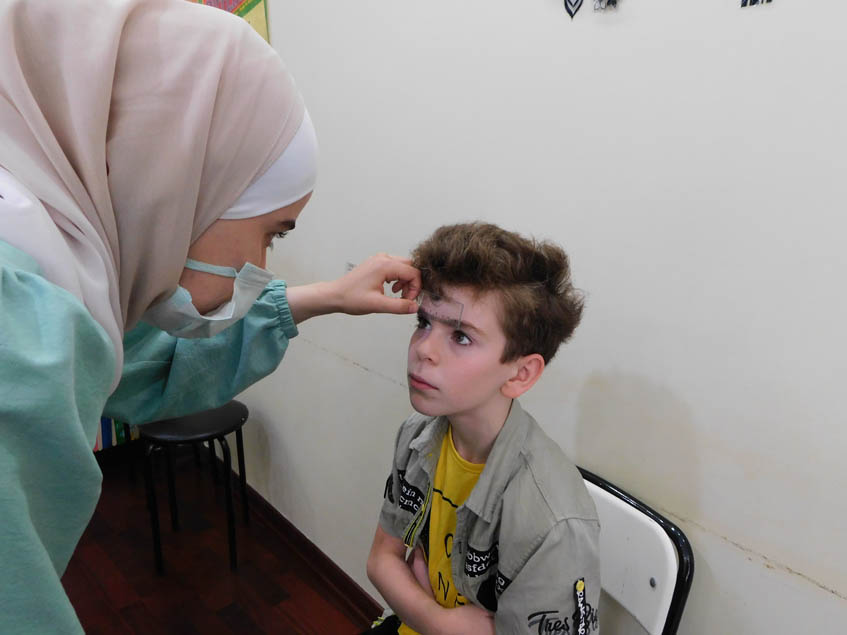 Recording the data of the students who need eyeglasses and handing it to Dr Yaman Al Muradi.