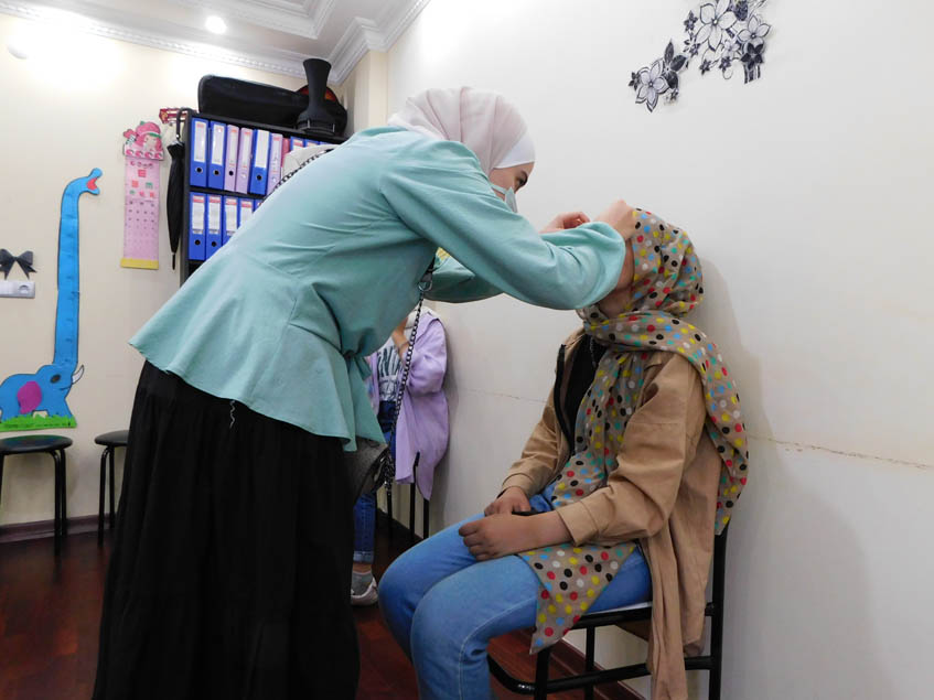 Recording the data of the students who need eyeglasses and handing it to Dr Yaman Al Muradi.