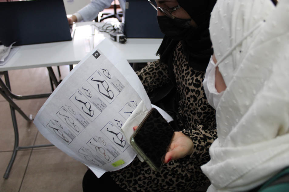 Recording the data of the students who need eyeglasses and handing it to Dr Yaman Al Muradi.