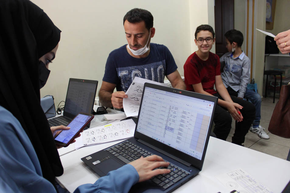 Recording the data of the students who need eyeglasses and handing it to Dr Yaman Al Muradi.